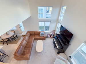 Living room featuring a high ceiling and light wood-type flooring