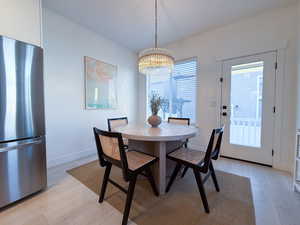 Dining area featuring a chandelier and light hardwood / wood-style floors