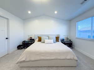 Carpeted bedroom with vaulted ceiling