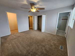 Unfurnished bedroom featuring carpet floors, a closet, connected bathroom, and ceiling fan