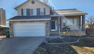 Tri-level home with a porch and a garage