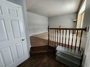 Staircase featuring hardwood / wood-style flooring