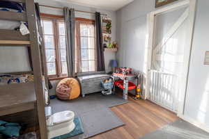 Bedroom featuring wood-style flooring