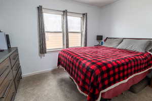 Bedroom featuring light carpet