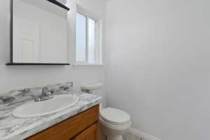 Bathroom with tile patterned floors, vanity, and toilet