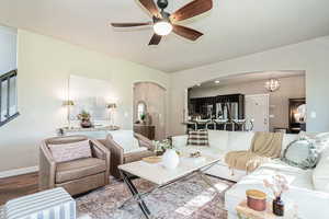 Living room featuring ceiling fan and wood-type flooring