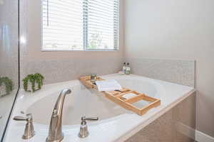 Bathroom with a wealth of natural light and a tub