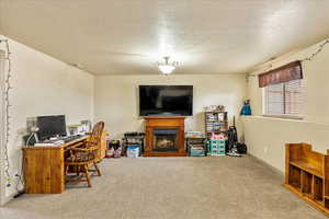 Office area with a textured ceiling and carpet