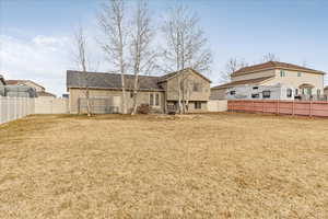 Rear view of house featuring a lawn