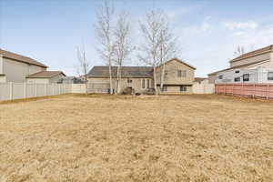 Back of house with a lawn