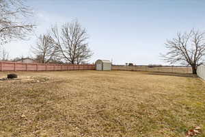 View of yard featuring a storage shed