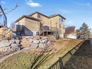 Back of house featuring a yard and a deck