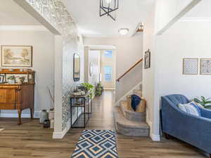 Foyer entrance featuring ornamental molding and dark hardwood / wood-style floors