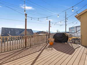 Wooden deck featuring a grill