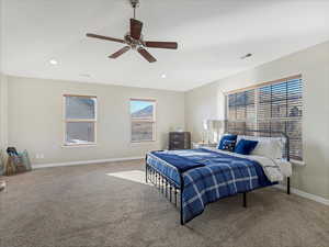 Bedroom with ceiling fan and carpet