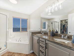 Bathroom featuring vanity, independent shower and bath, and tile patterned flooring