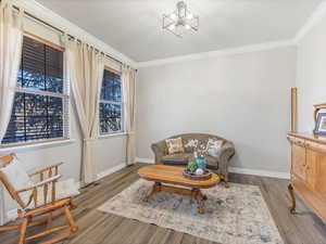 Sitting room featuring ornamental molding and light hardwood / wood-style flooring