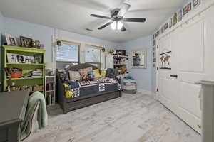 Bedroom featuring ceiling fan and light hardwood / wood-style flooring