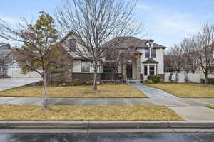 View of front facade featuring a garage and a front yard