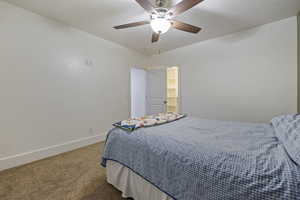 Bedroom with ceiling fan and carpet floors