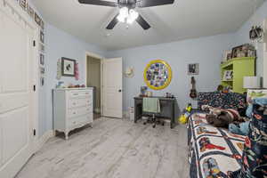 Bedroom featuring light hardwood / wood-style floors and ceiling fan