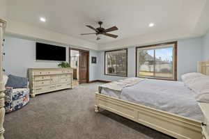 Bedroom with light colored carpet and ceiling fan