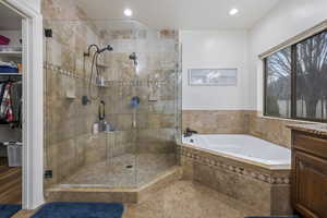 Bathroom with shower with separate bathtub and vanity