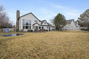 Rear view of house with a yard and a playground