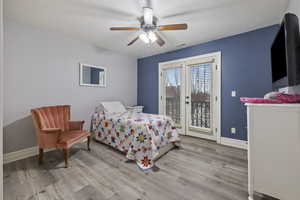 Bedroom featuring ceiling fan, light hardwood / wood-style flooring, and access to outside