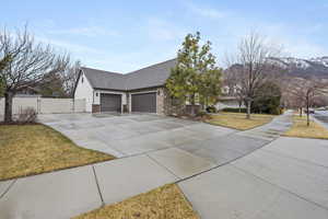 View of front of property with a mountain view, a garage, and a front yard