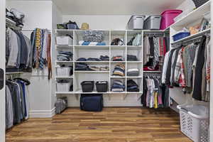 Spacious closet with hardwood / wood-style floors