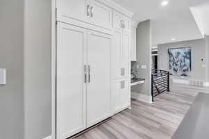 Kitchen featuring white cabinetry and light wood-type flooring