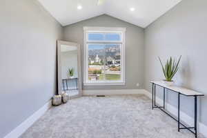 Interior space featuring lofted ceiling and light colored carpet