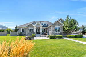 Craftsman-style home with a front lawn