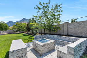 View of patio featuring an outdoor fire pit and a mountain view