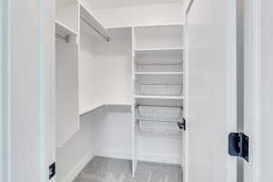 Spacious closet featuring carpet flooring