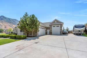 View of front of home with a garage and a mountain view