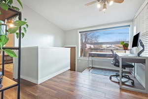 Office area featuring hardwood / wood-style flooring and vaulted ceiling