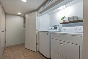 Washroom with washer and clothes dryer