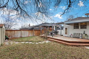 View of yard featuring a wooden deck and a pergola