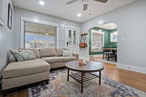 Living room featuring ceiling fan and hardwood / wood-style floors