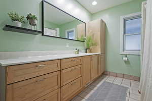 Bathroom featuring tile patterned flooring and vanity