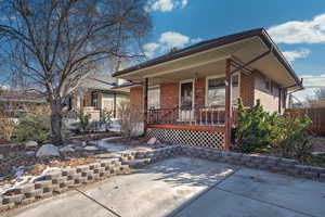 View of front facade featuring a porch and a patio area