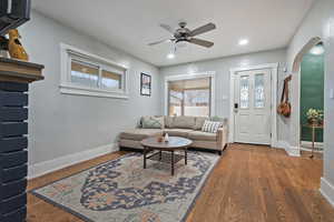 Living room featuring wood-type flooring and ceiling fan