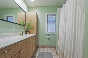 Bathroom featuring tile patterned floors and vanity