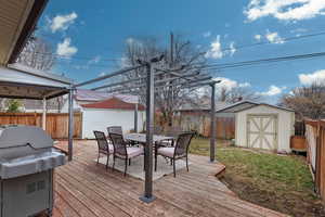 Wooden deck with area for grilling and a storage unit