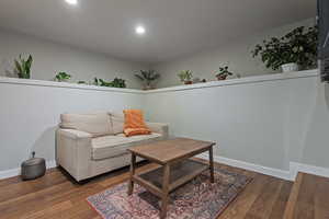 Living room with dark hardwood / wood-style flooring