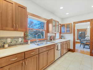 Kitchen featuring dishwasher, sink, and light tile patterned floors