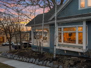 Property exterior at dusk featuring a porch