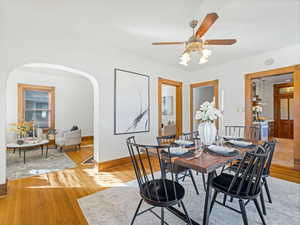 Dining space with ceiling fan and light wood-type flooring